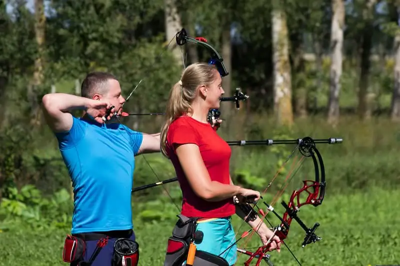 Man and Woman Shooting Compound Bows