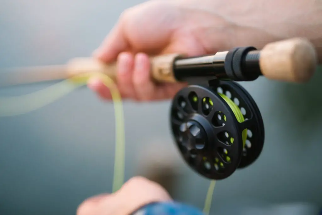Black centerpin reel on a fishing rod close up shot