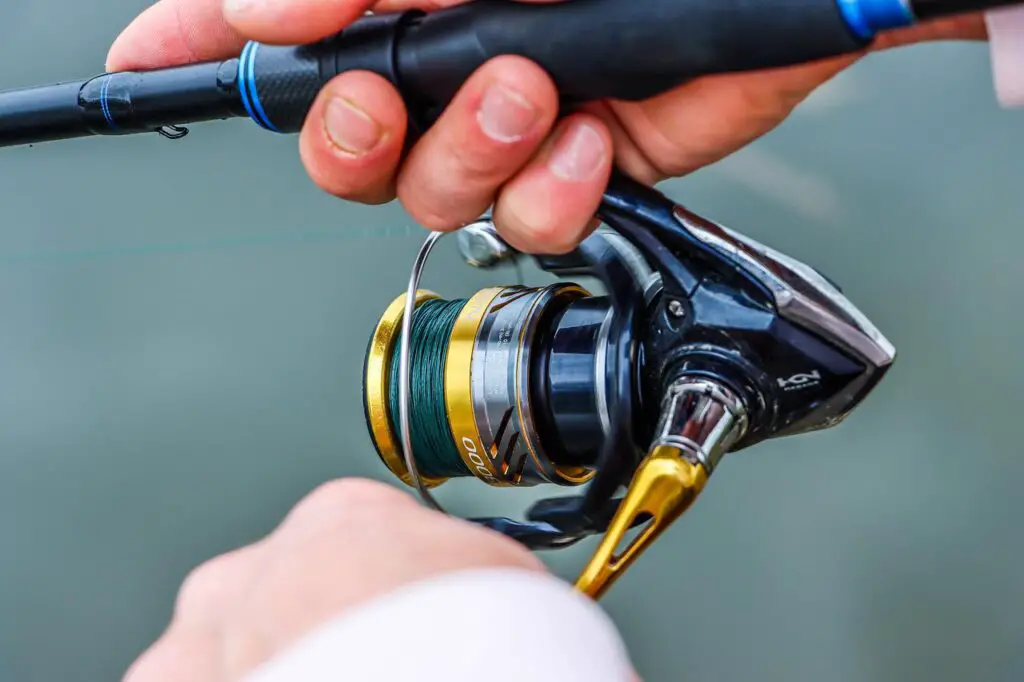 Silver with gold accent colored spinning reel close up shot
