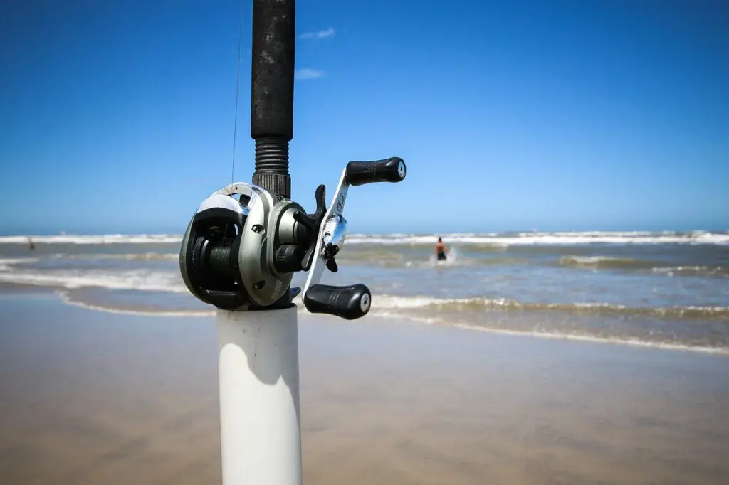 Fishing rod with a surf fishing reel mounted on a pvc pipe near the sea shore