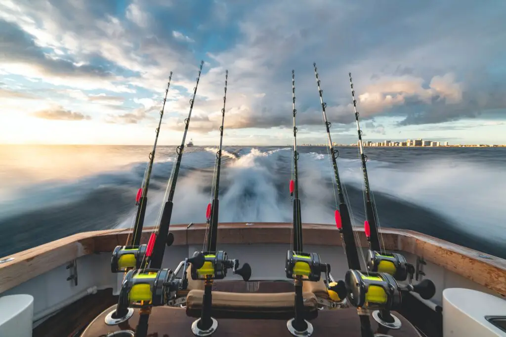 Six fishing rods mounted in the back of a fast moving speed boat