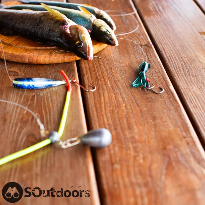 Cutting board on a wooden table in the kitchen with fishing lures